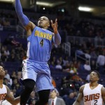 Denver Nuggets' Randy Foye (4) drives past Phoenix Suns' Eric Bledsoe (2) for a score during the second half of an NBA basketball game Wednesday, Dec. 23, 2015, in Phoenix. The Nuggets defeated the Suns 104-96. (AP Photo/Ross D. Franklin)