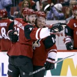 Arizona Coyotes' Oliver Ekman-Larsson, left, of Sweden,and Max Domi celebrate after Ekman-Larsson's game-tying goal against the Los Angeles Kings during the third period of an NHL hockey game Saturday, Dec. 26, 2015, in Glendale, Ariz. The Kings defeated the Coyotes 4-3 in overtime. (AP Photo/Ralph Freso)
