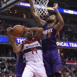 Washington Wizards guard Gary Neal (14) goes to the basket against Phoenix Suns forward Markieff Morris (11) during the second half of an NBA basketball game, Friday, Dec. 4, 2015, in Washington. The Wizards won 109-106. (AP Photo/Nick Wass)