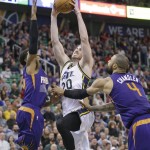 Utah Jazz forward Gordon Hayward (20) goes to the basket as Phoenix Suns' Ronnie Price, left, and Tyson Chandler (4) defend during the second quarter of an NBA basketball game Monday, Dec. 21, 2015, in Salt Lake City. (AP Photo/Rick Bowmer)