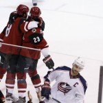 Arizona Coyotes' Tobias Rieder (8), of Germany, celebrates his goal with Oliver Ekman-Larsson (23), of Sweden, as Columbus Blue Jackets' Nick Foligno (71) skates past during the second period of an NHL hockey game, Thursday, Dec. 17, 2015, in Glendale, Ariz. (AP Photo/Ross D. Franklin)