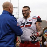 Arizona linebacker Scooby Wright III, right, receives from New Mexico Bowl executive director Jeff Simbieda the Defensive Player of the Game award after the NCAA college football game against New Mexico in Albuquerque, N.M., Saturday, Dec. 19, 2015. Arizona won 45-37. (AP Photo/Andres Leighton)