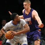 Phoenix Suns center Alex Len (21) defends Brooklyn Nets forward Thaddeus Young in the first half of an NBA basketball game at the Barclays Center, Tuesday, Dec. 1, 2015, in New York. (AP Photo/Kathy Willens)