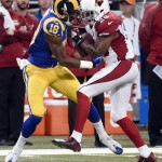 Arizona Cardinals free safety Rashad Johnson, right, intercepts a pass intended for St. Louis Rams wide receiver Kenny Britt during the first quarter of an NFL football game on Sunday, Dec. 6, 2015, in St. Louis. (AP Photo/L.G. Patterson)