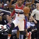Washington Wizards guard Bradley Beal (3) head downcourt with the ball in front of Phoenix Suns guard Brandon Knight, back, during the second half of an NBA basketball game, Friday, Dec. 4, 2015, in Washington. (AP Photo/Nick Wass)
