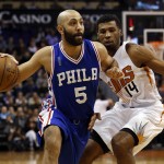 Philadelphia 76ers guard Kendall Marshall (5) drives past Phoenix Suns guard Ronnie Price in the first quarter during an NBA basketball game, Saturday, Dec. 26, 2015, in Phoenix. (AP Photo/Rick Scuteri)