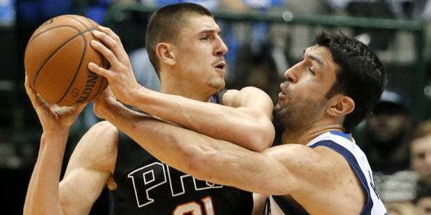 Phoenix Suns center Alex Len, left, of Ukraine attempts to get to the basket as Dallas Mavericks ce...