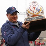 Arizona head coach Rich Rodriguez lifts the New Mexico Bowl trophy after his team won 45-37 over New Mexico in the NCAA college football game in Albuquerque, N.M., Saturday, Dec. 19, 2015. (AP Photo/Andres Leighton)
