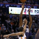 Oklahoma City Thunder forward Kevin Durant (35) shoots over Phoenix Suns forward T.J. Warren, front, in the first quarter of an NBA basketball game in Oklahoma City, Thursday, Dec. 31, 2012. (AP Photo/Sue Ogrocki)