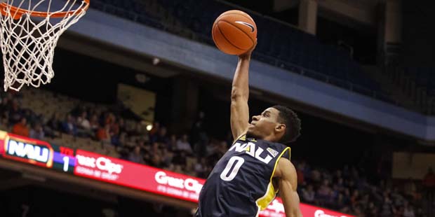 Northern Arizona's Torry Johnson (0) goes up to attempt a dunk during the second half of an NCAA co...