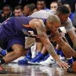 Phoenix Suns Brandon Knight, left, and Brooklyn Nets forward Joe Johnson dive for the ball in the first half of an NBA basketball game at the Barclays Center, Tuesday, Dec. 1, 2015, in New York. (AP Photo/Kathy Willens)
