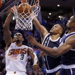 Phoenix Suns guard Brandon Knight (3) dunks in front of Oklahoma City Thunder guard Russell Westbrook, center, and forward Serge Ibaka, right, in the fourth quarter of an NBA basketball game in Oklahoma City, Thursday, Dec. 31, 2015. Oklahoma City won 110-106. (AP Photo/Sue Ogrocki)
