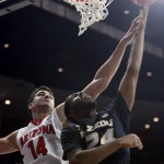Missouri forward Kevin Puryear shoots in front of Arizona center Dusan Ristic (14) during the first half of an NCAA college basketball game, Sunday, Dec. 13, 2015, in Tucson, Ariz. (AP Photo/Rick Scuteri)