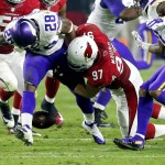 Minnesota Vikings running back Adrian Peterson (28) fumbles after being hit by Arizona Cardinals nose tackle Josh Mauro (97) during the second half of an NFL football game, Thursday, Dec. 10, 2015, in Glendale, Ariz. (AP Photo/Rick Scuteri)