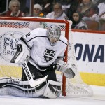 Los Angeles Kings goalie Jonathan Quick, left, makes a save on a shot by the Arizona Coyotes as Kings defenseman Jake Muzzin watches the puck during the third period of an NHL hockey game, Saturday, Dec. 26, 2015, in Glendale, Ariz. The Kings defeated the Coyotes 4-3 in overtime. (AP Photo/Ralph Freso)
