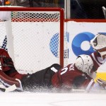Arizona Coyotes' Anders Lindback, of Sweden, gives up a goal to Carolina Hurricanes' Phil Di Giuseppe during the second period of an NHL hockey game Saturday, Dec. 12, 2015, in Glendale, Ariz. (AP Photo/Ross D. Franklin)