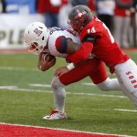 Arizona quarterback Anu Solomon, left, pushes his way to the end zone to score a touchdown against the defense of New Mexico safety Daniel Henry during the first half of the New Mexico Bowl NCAA college football game in Albuquerque, N.M., Saturday, Dec. 19, 2015. (AP Photo/Andres Leighton)