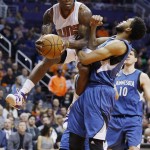 Phoenix Suns' Eric Bledsoe (2) looks to pass the ball as Minnesota Timberwolves' Karl-Anthony Towns, right, defends during the first half of an NBA basketball game, Sunday, Dec. 13, 2015 in Phoenix. (AP Photo/Ross D. Franklin)