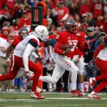New Mexico quarterback Lamar Jordan, center, rushes to the end zone between the defense of Arizona free safety Jamar Allah, left, and safety Will Parks during the first half of the New Mexico Bowl NCAA college football game in Albuquerque, N.M., Saturday, Dec. 19, 2015. Arizona won 45-37. (AP Photo/Andres Leighton)