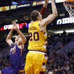 Cleveland Cavaliers' Timofey Mozgov (20), of Russia, drives past Phoenix Suns' Alex Len (21), of Ukraine, for a dunk during the first half of an NBA basketball game Monday, Dec. 28, 2015, in Phoenix. (AP Photo/Ross D. Franklin)