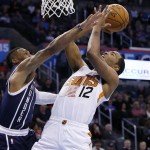Phoenix Suns forward T.J. Warren (12) is fouled by Oklahoma City Thunder guard Russell Westbrook, left, while shooting in the third quarter of an NBA basketball game in Oklahoma City, Thursday, Dec. 31, 2015. Oklahoma City won 110-106. (AP Photo/Sue Ogrocki)