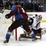 Arizona Coyotes goalie Anders Lindback, right, of Sweden, stops a shot off the stick of Colorado Avalanche right wing Jack Skille in the first period of an NHL hockey game Sunday, Dec. 27, 2015, in Denver. (AP Photo/David Zalubowski)