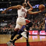 Chicago Bulls' Derrick Rose (1), goes up for a shot against Phoenix Suns' Jon Leuer (30), during the second half of a basketball game Monday, Dec. 7, 2015, in Chicago. Phoenix won 103-101. (AP Photo/Paul Beaty)