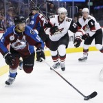 Colorado Avalanche right wing Jarome Iginla (12), left, looks to pass the puck as Arizona Coyotes defensemen Oliver Ekman-Larsson, center, of Sweden, and defenseman Connor Murphy defend in the first period of an NHL hockey game Sunday, Dec. 27, 2015, in Denver. (AP Photo/David Zalubowski)