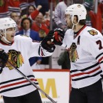 Chicago Blackhawks' Brent Seabrook (7) celebrates his goal against the Arizona Coyotes with Patrick Kane, left, during the first period of an NHL hockey game Tuesday, Dec. 29, 2015, in Glendale, Ariz. (AP Photo/Ross D. Franklin)