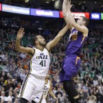 Phoenix Suns forward Jon Leuer (30) shoots as Utah Jazz forward Trey Lyles (41) defends during the first quarter of an NBA basketball game Monday, Dec. 21, 2015, in Salt Lake City. (AP Photo/Rick Bowmer)