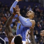 Denver Nuggets' Randy Foye (4) shootsover Phoenix Suns' Eric Bledsoe (2) during the second half of an NBA basketball game Wednesday, Dec. 23, 2015, in Phoenix. (AP Photo/Ross D. Franklin)