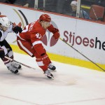 Detroit Red Wings defenseman Alexey Marchenko (47) of Russia keeps the puck away from Arizona Coyotes center Dustin Jeffrey (37) during the first period of an NHL hockey game in Detroit, Thursday, Dec. 3, 2015.  (AP Photo/Jose Juarez)