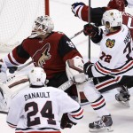 Arizona Coyotes' Louis Domingue (35) gets some help making a save by Coyotes' Zbynek Michalek (4), of the Czech Republic, as Chicago Blackhawks' Artemi Panarin (72), of Russia, and Phillip Danault (24) close in during the third period of an NHL hockey game Tuesday, Dec. 29, 2015, in Glendale, Ariz.  The Blackhawks won 7-5. (AP Photo/Ross D. Franklin)