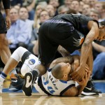 Dallas Mavericks guard Devin Harris, on floor, fights for control of the ball against Phoenix Suns guard Ronnie Price, top, in the first half of an NBA basketball game, Monday, Dec. 14, 2015, in Dallas. (AP Photo/Tony Gutierrez)