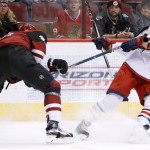 Columbus Blue Jackets' David Clarkson (23) tries to avoid the high stick by Arizona Coyotes' Klas Dahlbeck, left, of Sweden, during the first period of an NHL hockey game, Thursday, Dec. 17, 2015, in Glendale, Ariz. (AP Photo/Ross D. Franklin)