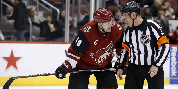 Arizona Coyotes' Shane Doan (19) talks with referee Kelly Sutherland, right, during the second peri...