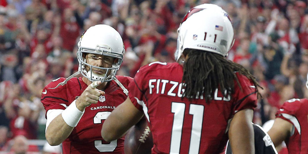 Arizona Cardinals quarterback Carson Palmer (3) points to wide receiver Larry Fitzgerald (11) after...