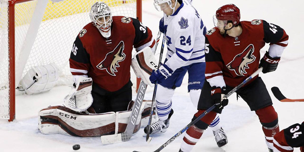 Arizona Coyotes' Louis Domingue (35) makes a save on a shot by Toronto Maple Leafs' Peter Holland (...
