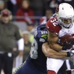 Arizona Cardinals free safety Tyrann Mathieu is tackled by Seattle Seahawks tight end Jimmy Graham after he intercepted a pass during the second half of an NFL football game, Sunday, Nov. 15, 2015, in Seattle. (AP Photo/Elaine Thompson)