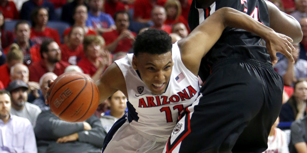 Arizona guard Allonzo Trier, left, drives around Fresno State center Terrell Carter II during the s...