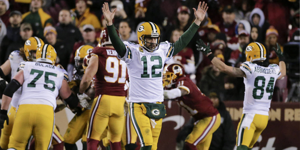 Green Bay Packers quarterback Aaron Rodgers (12) celebrates after running back Eddie Lacy scored du...