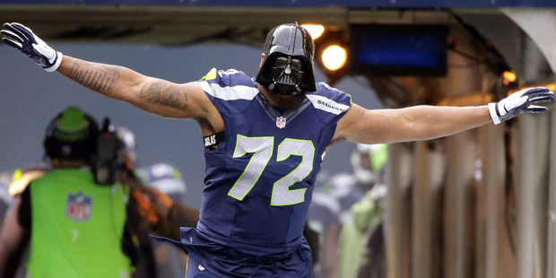 Seattle Seahawks' Michael Bennett wears a "Darth Vader" mask as he runs onto the field during prega...