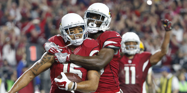 Arizona Cardinals wide receiver Michael Floyd (15) celebrates his touchdown catch with Jaron Brown ...