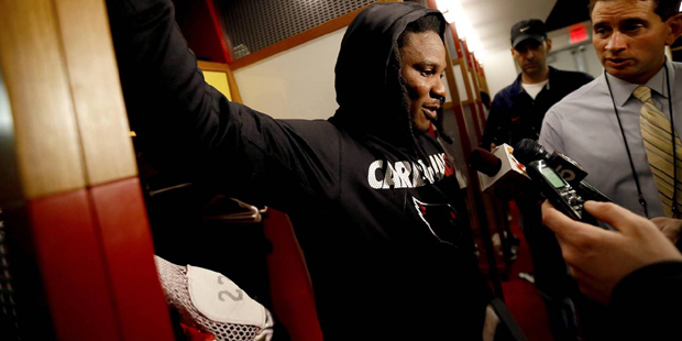 Arizona Cardinals running back Chris Johnson talks to reporters while he cleans out his locker, Mon...