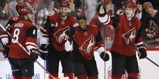 Arizona Coyotes' Anthony Duclair, middle, smiles as he celebrates his goal against the Nashville Pr...