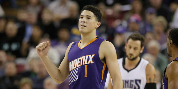Phoenix Suns guard Devin Booker, pumps his fist after scoring against the Sacramento Kings during t...