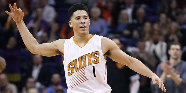 Phoenix Suns' Devin Booker celebrates a 3 point shot against the Charlotte Hornets during the secon...