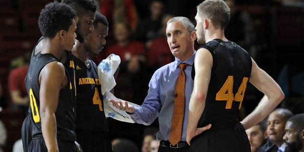 Arizona State head coach Bobby Hurley, second from right, huddles with members of his team during t...