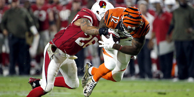 Arizona Cardinals free safety Rashad Johnson (26) tackles Cincinnati Bengals wide receiver Mohamed ...