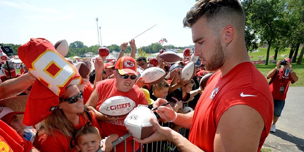 Kansas City Chiefs tight end Travis Kelce signs autographs after NFL football training camp practic...